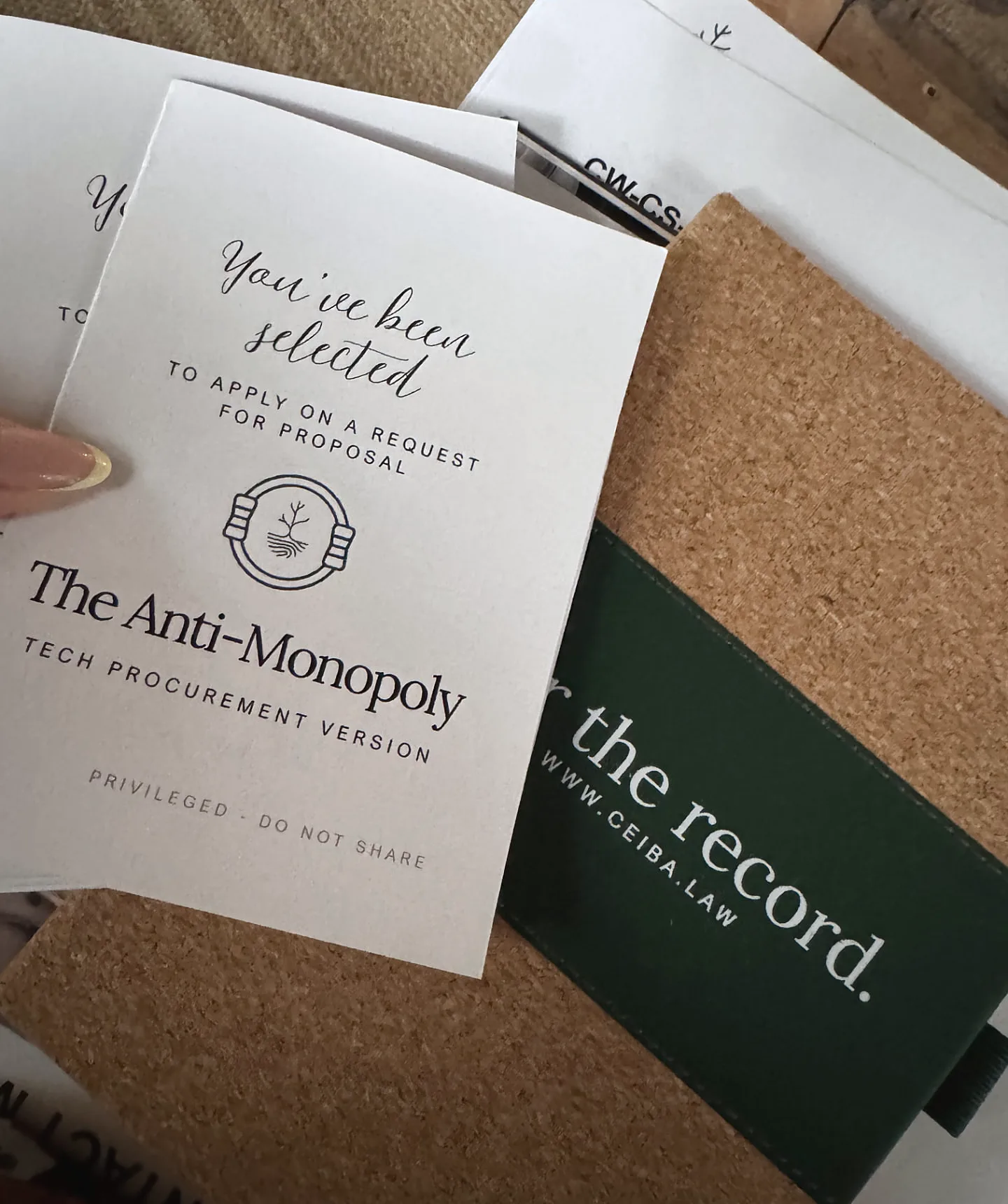 The Anti-Monopoly tech procurement booklet beside a Ceiba notebook.