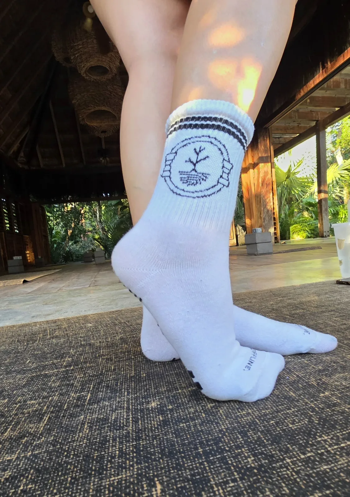 Ceiba Wellness grip sock with the tree logo